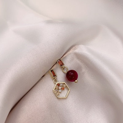 Red pearl and hexagon honeycomb mismatch earrings | Hotel Del Luna | IU